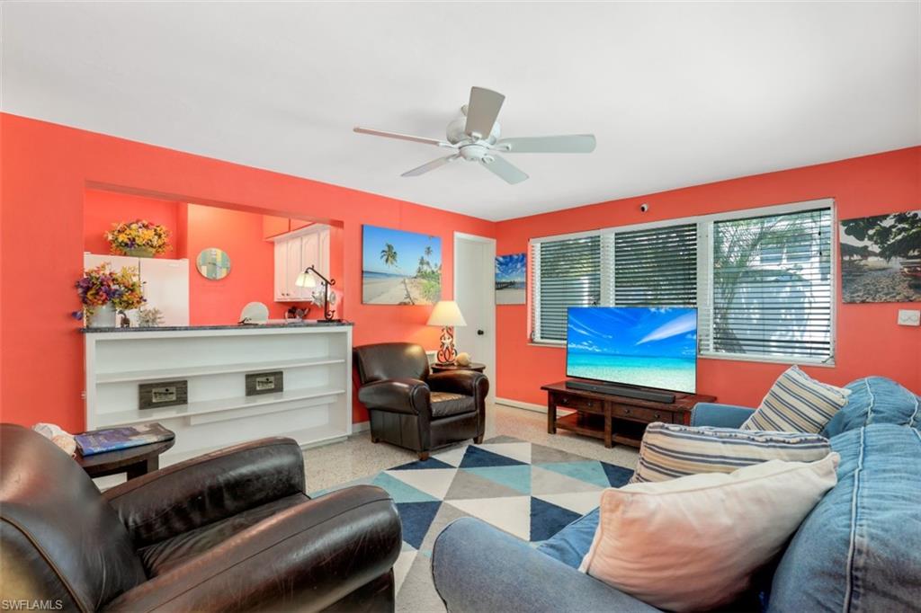 409 3rd Avenue North Naples, FL 34102 - Photo 20 of 41 a living room with furniture a fireplace and a floor to ceiling window