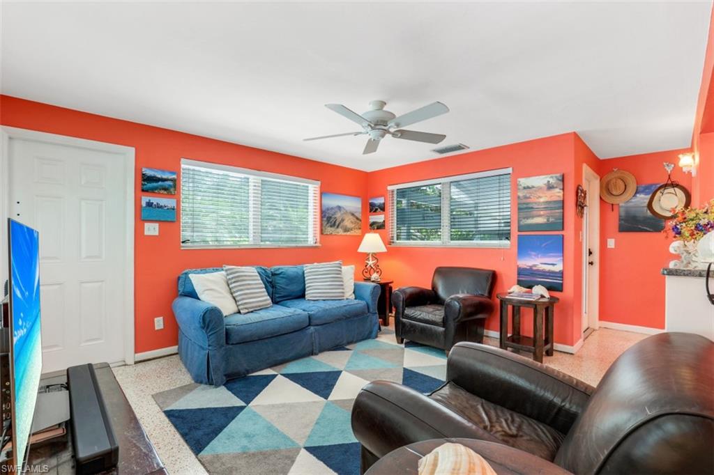 409 3rd Avenue North Naples, FL 34102 - Photo 22 of 41 a living room with furniture a table and a chandelier