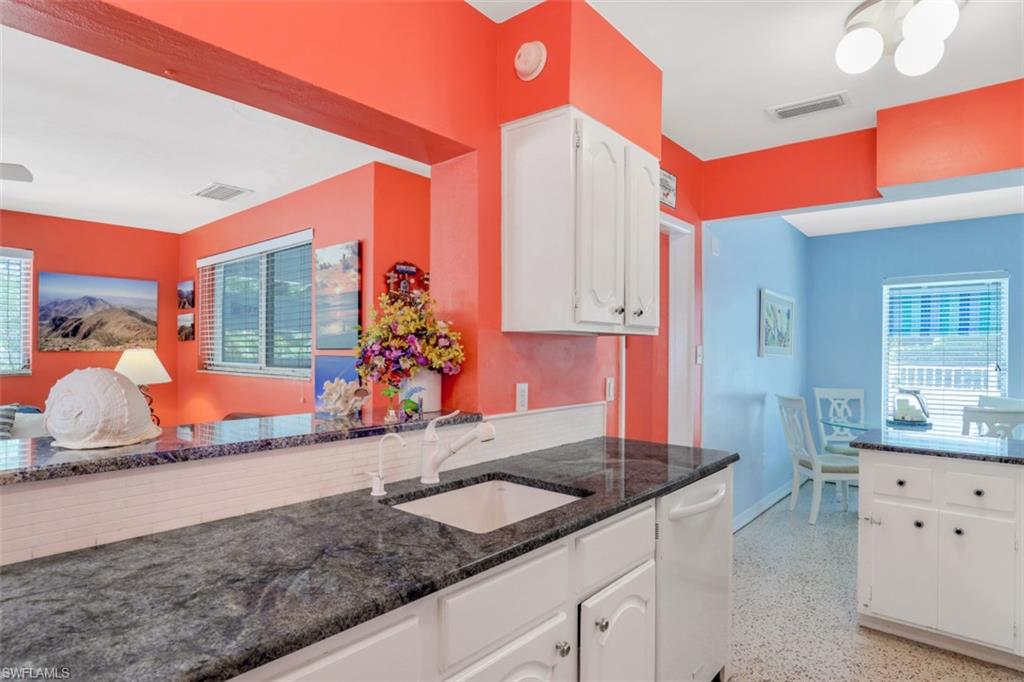 409 3rd Avenue North Naples, FL 34102 - Photo 23 of 41 a kitchen with sink a counter and cabinets