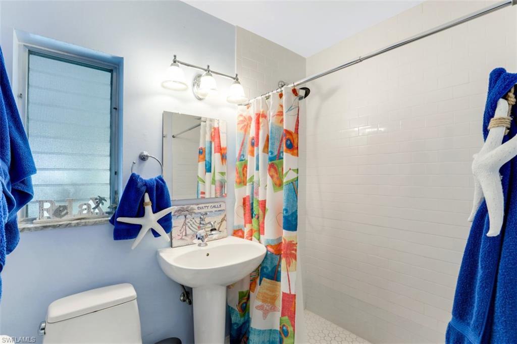 409 3rd Avenue North Naples, FL 34102 - Photo 30 of 41 a bathroom with a sink toilet and shower