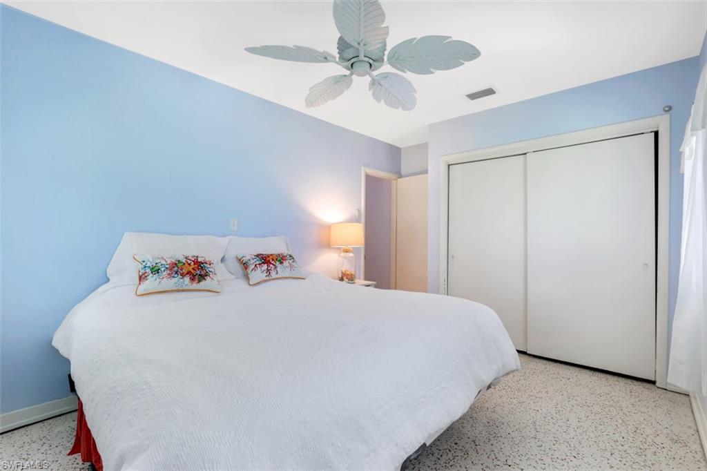 409 3rd Avenue North Naples, FL 34102 - Photo 31 of 41 a bedroom with a bed and a ceiling fan