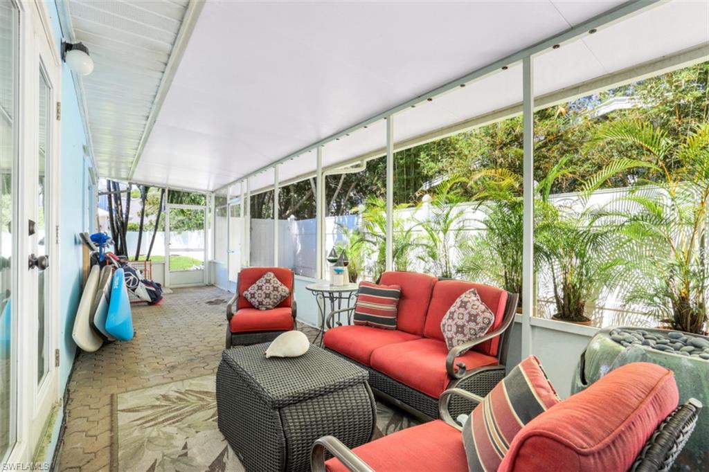 409 3rd Avenue North Naples, FL 34102 - Photo 32 of 41 a living room with furniture a rug and a large window