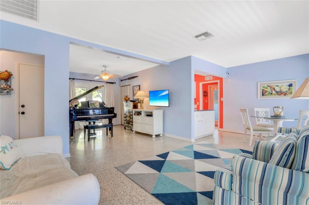 409 3rd Avenue North Naples, FL 34102 - Photo 7 of 41 a living room with furniture and a dining table with projector kitchen view
