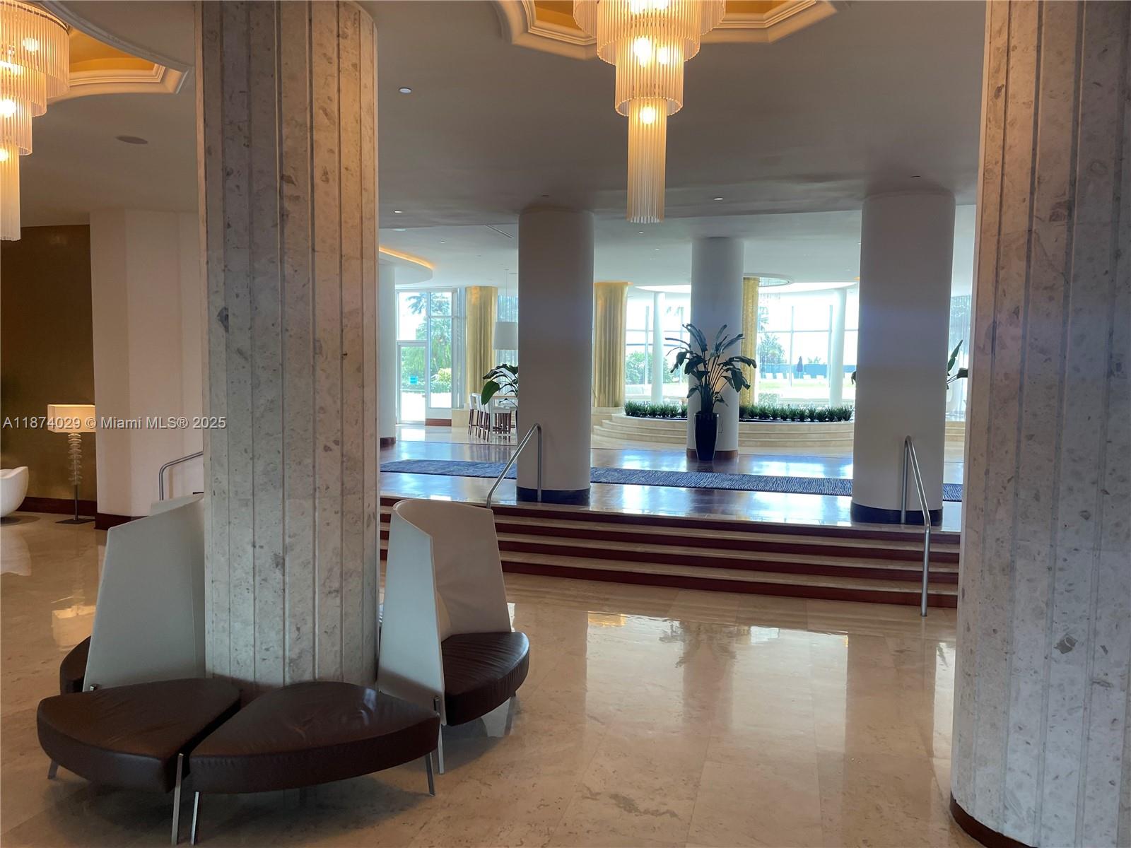 5151 Collins Avenue, Unit 1525 Miami Beach, FL 33140 - Photo 13 of 17 a room with furniture and a large window