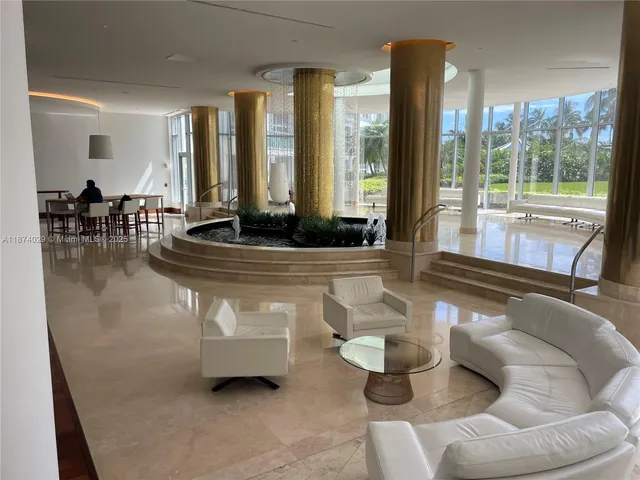 a living room with furniture and large windows