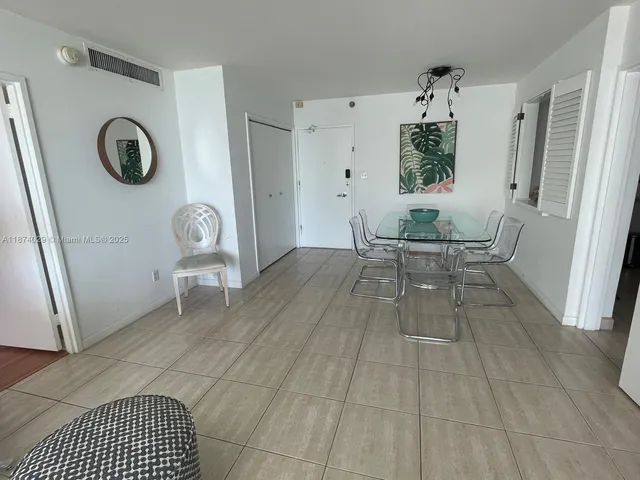 a living room with a couch and a clock on a table