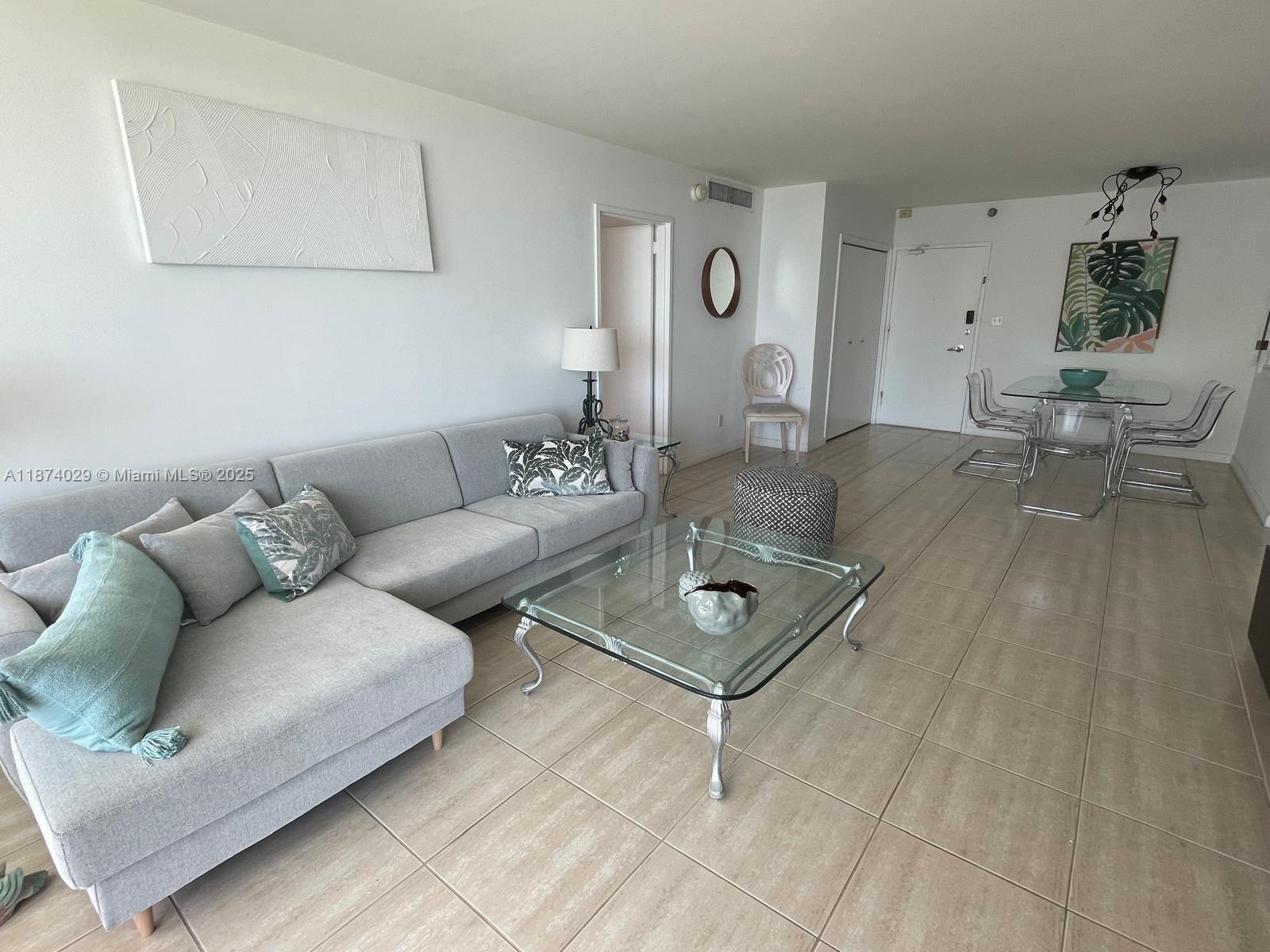 5151 Collins Avenue, Unit 1525 Miami Beach, FL 33140 - Photo 5 of 17 a living room with furniture and wooden floor