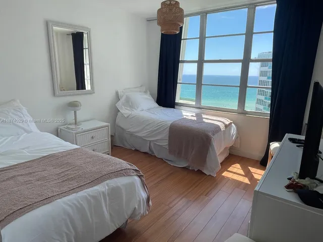 a bedroom with two beds and a window