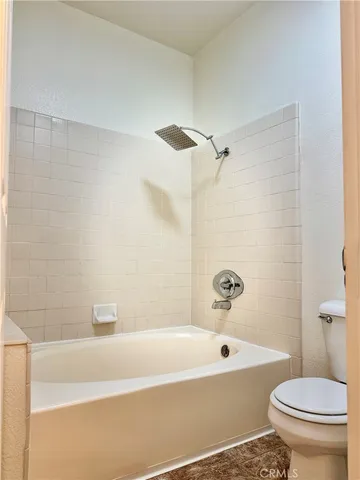 a bathroom with a bathtub and a toilet