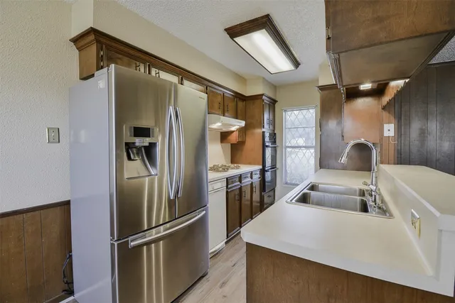 a kitchen with refrigerator and car