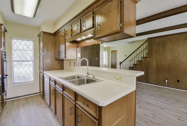 a kitchen with a sink a refrigerator and window