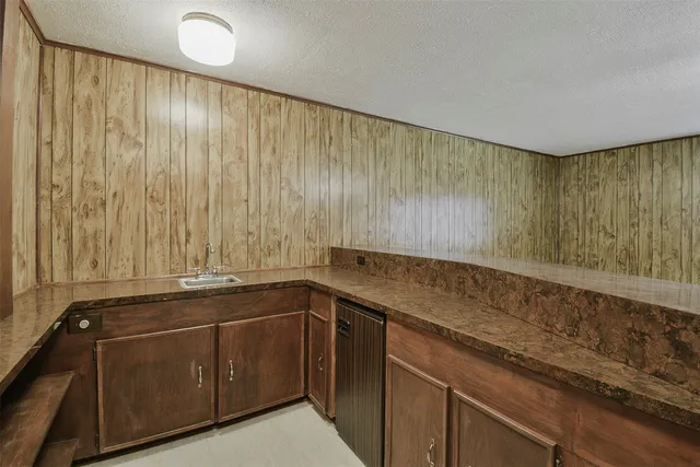 a room with a sink and cabinets