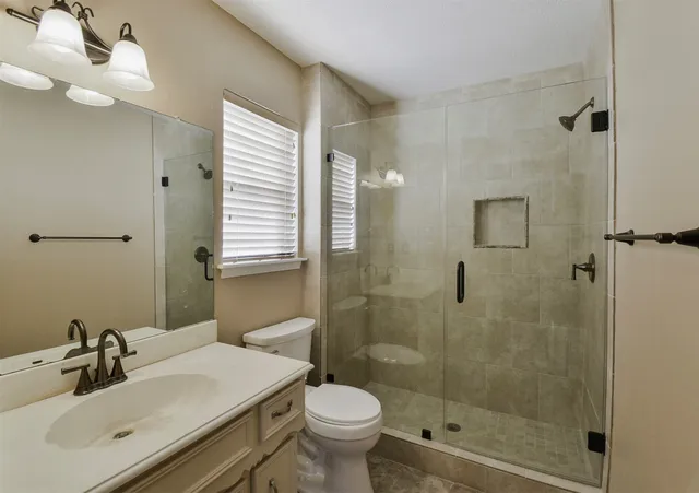 a bathroom with a sink toilet and shower