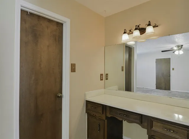 a bathroom with a sink vanity and a mirror