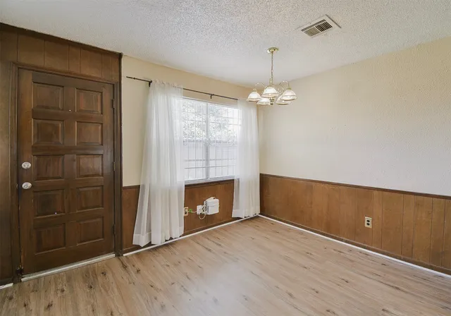 wooden floor in an empty room with a fireplace