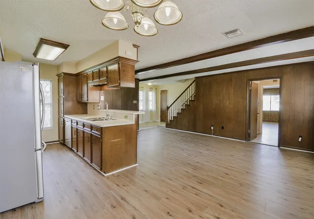 a kitchen with stainless steel appliances granite countertop a sink and cabinets