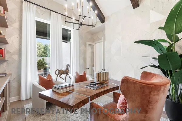a living room with furniture potted plant and a window