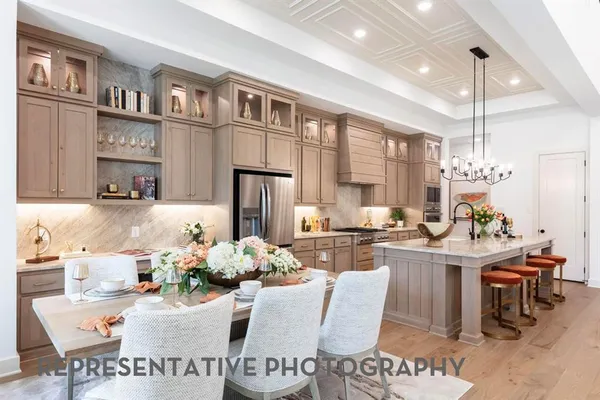 a living room with furniture kitchen view and a chandelier