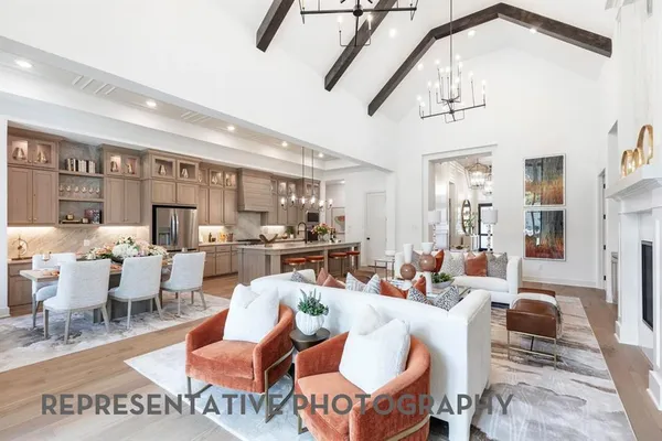 a living room with lots of furniture and view of kitchen