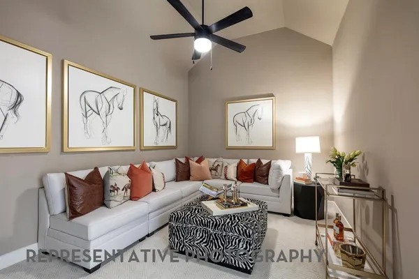 a living room with furniture ceiling fan and a rug