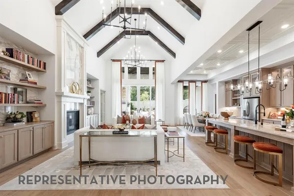 a living room with fireplace furniture and a chandelier