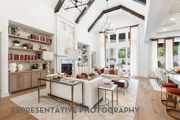a living room with furniture a flat screen tv and a stove