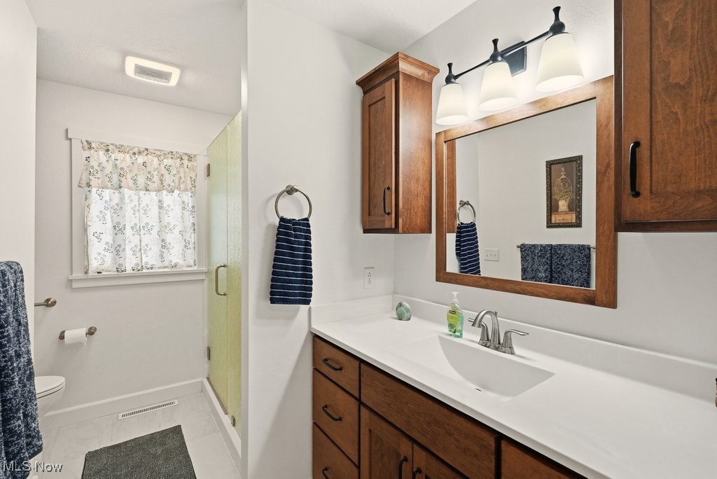 1430 Magnolia Road Southwest Dellroy, OH 44620 - Photo 22 of 50 Updated bathroom with modern vanity, clean finishes, and walk-in shower.