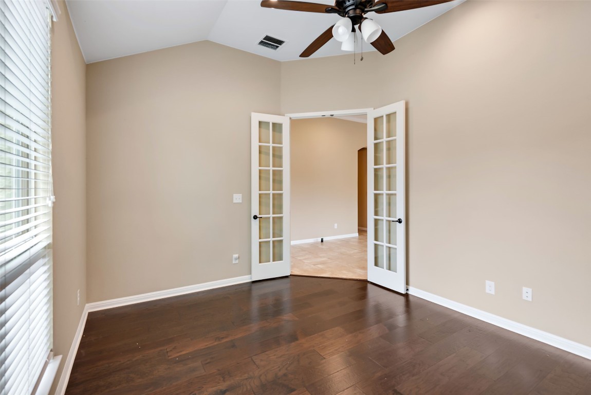 2000 Manada Trail Leander, TX 78641 - Photo 8 of 36 French doors open into a versatile room with vaulted ceilings and rich hardwood flooring.