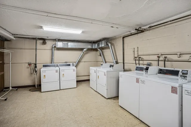 a view of a chair and table in backyard of the house