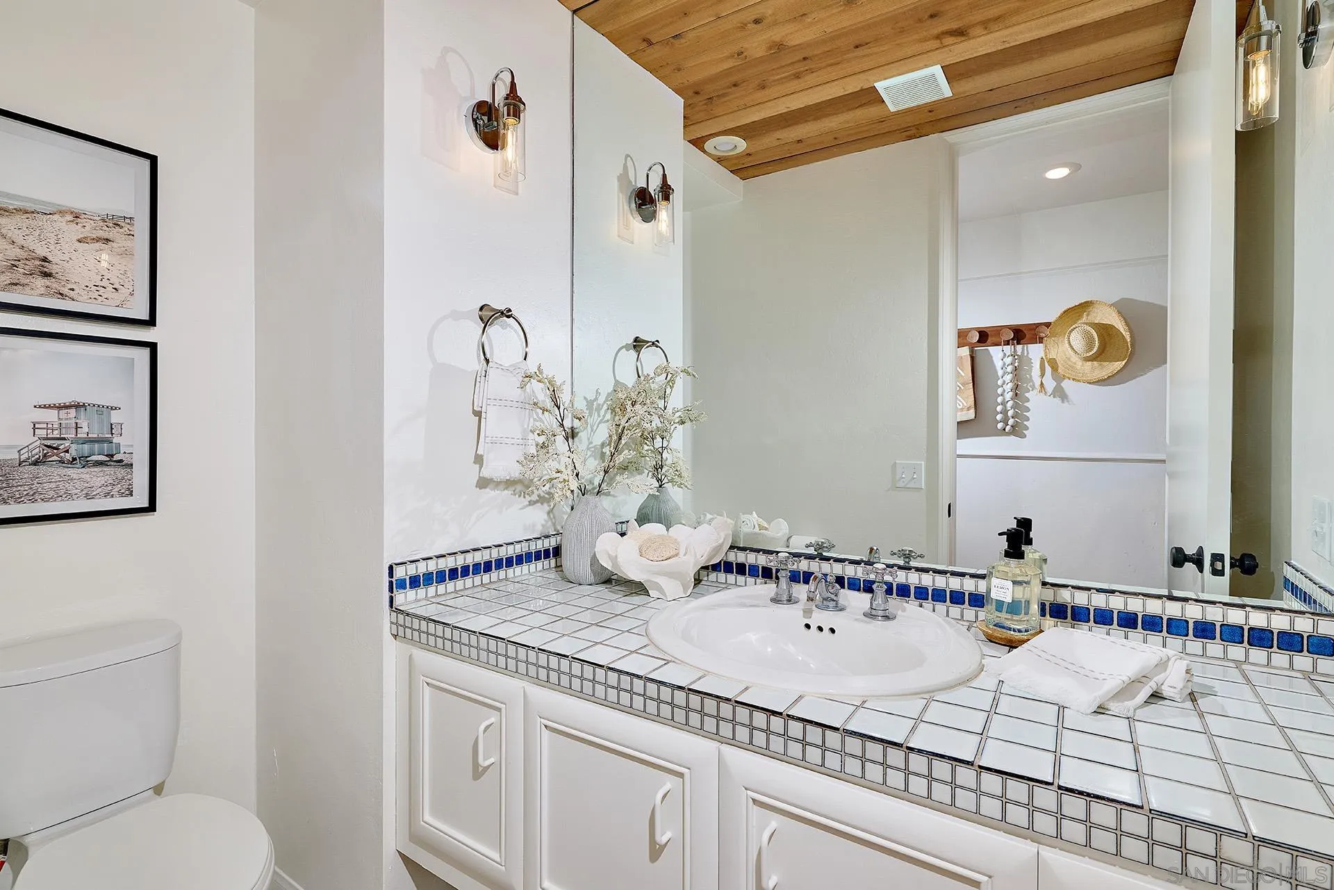 13765 Condesa Drive Del Mar, CA 92014 - Photo 50 of 75 a bathroom with a granite countertop sink and a mirror