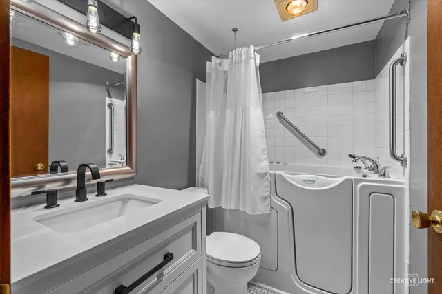 a bathroom with a sink mirror toilet and shower