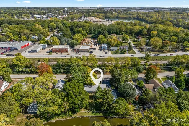 a picture of a room with a white wall and a refrigerator