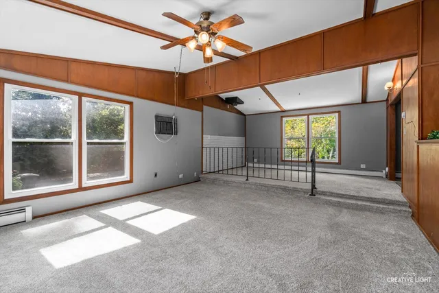 a view of a livingroom with a ceiling fan and window