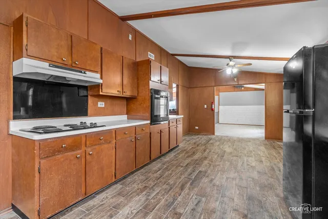 a kitchen with a stove a refrigerator and a oven
