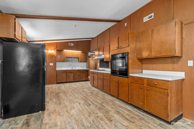 a kitchen with stainless steel appliances a refrigerator and a stove