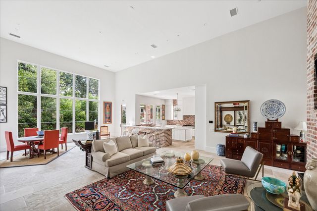 a living room with furniture couches and a large window