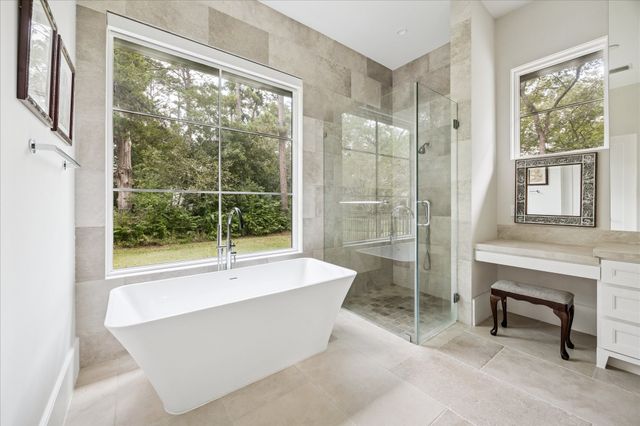 a bathroom with a bathtub and next to a window