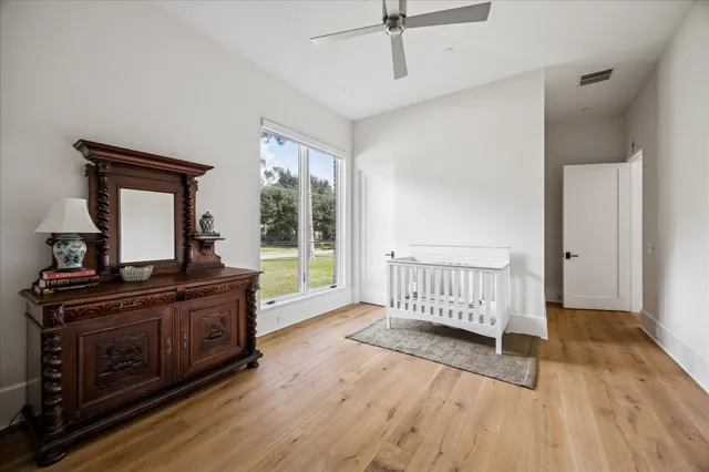 a bedroom with a bed and wooden floor