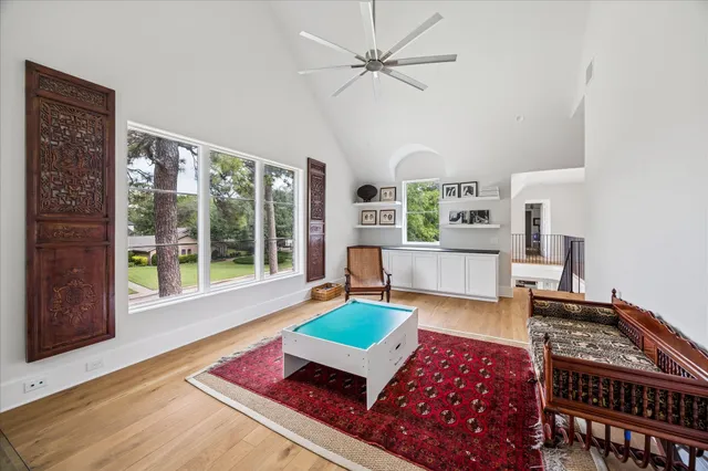 a living room with furniture and a floor to ceiling window