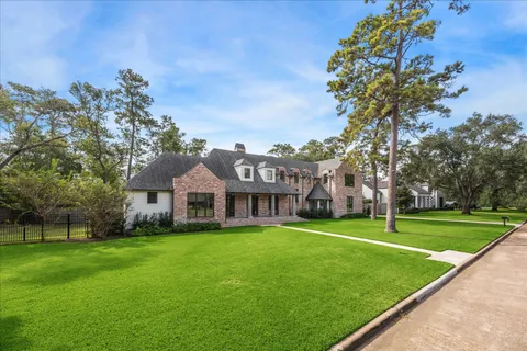 a view of a big yard with a house in the background