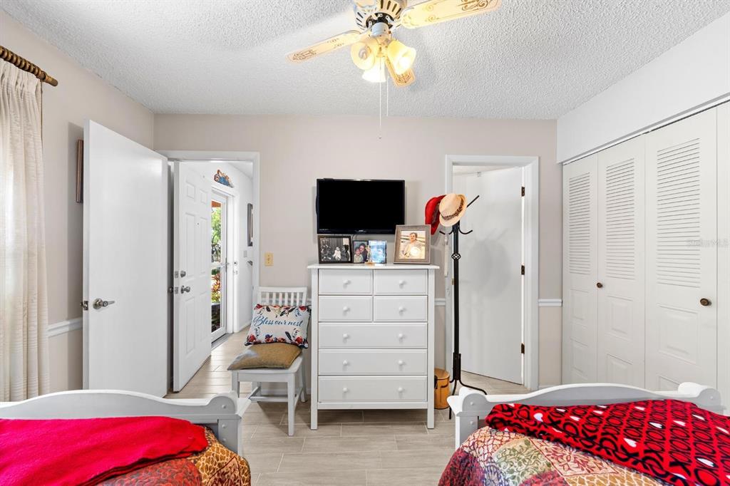 11404 Stansberry Drive Port Richey, FL 34668 - Photo 13 of 30 a bedroom with a bed and a flat tv screen