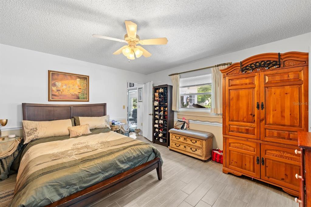 11404 Stansberry Drive Port Richey, FL 34668 - Photo 15 of 30 a bedroom with a bed and a chandelier