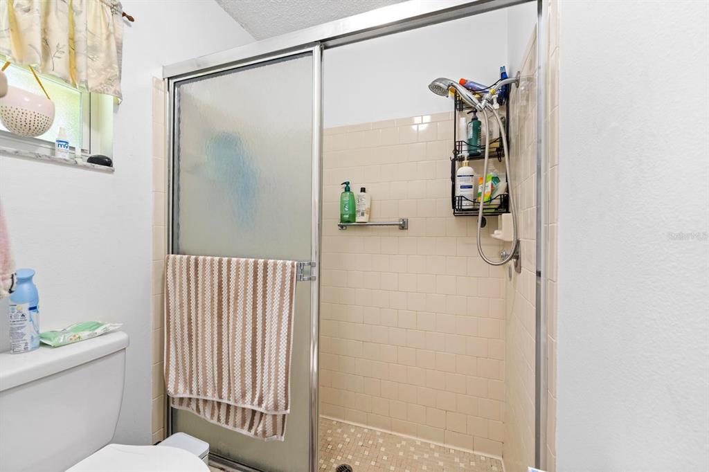 11404 Stansberry Drive Port Richey, FL 34668 - Photo 18 of 30 a bathroom with a shower and a toilet
