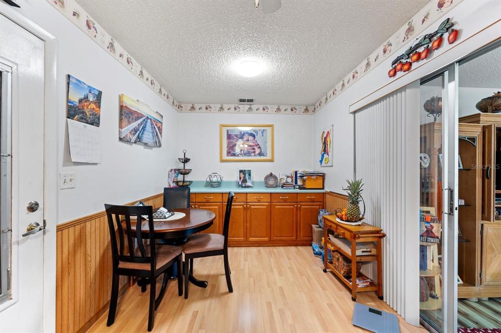 11404 Stansberry Drive Port Richey, FL 34668 - Photo 19 of 30 a view of a dining room with furniture and wooden floor
