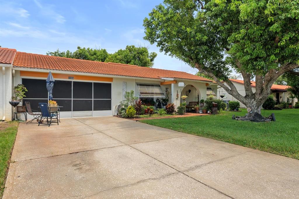 11404 Stansberry Drive Port Richey, FL 34668 - Photo 2 of 30 a house view with a garden space