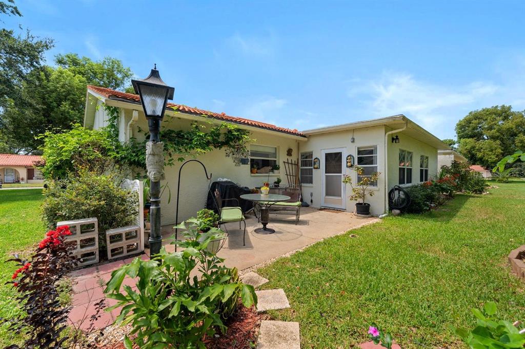 11404 Stansberry Drive Port Richey, FL 34668 - Photo 22 of 30 a front view of a house with garden and sitting area