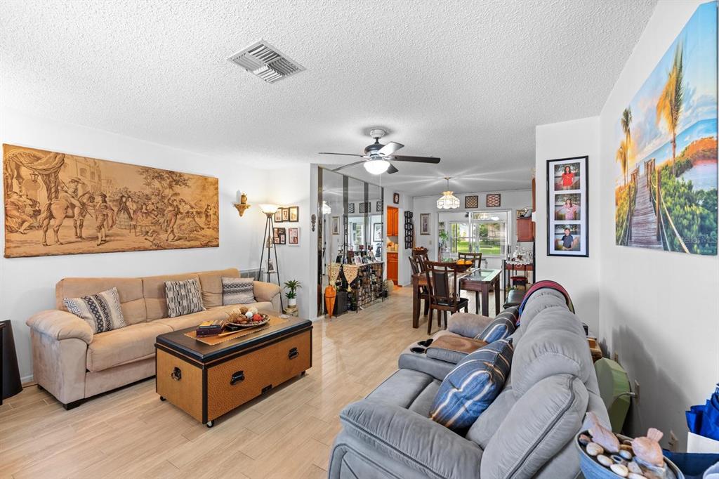 11404 Stansberry Drive Port Richey, FL 34668 - Photo 7 of 30 a living room with furniture and wooden floor