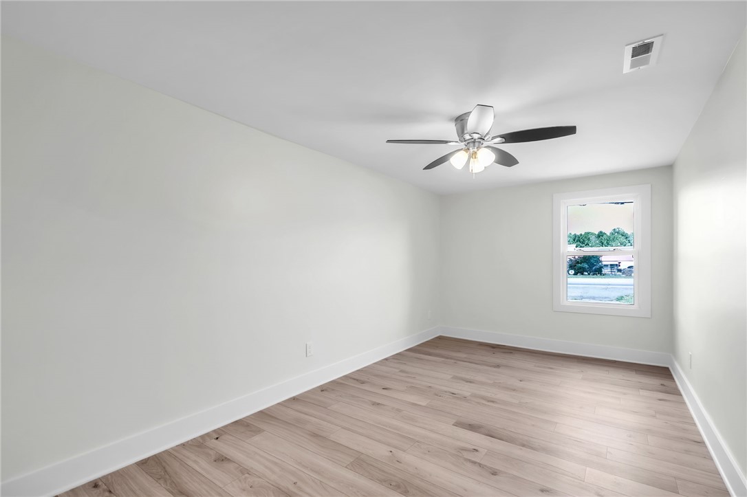 7 Beaverdam Road Williamston, SC 29697 - Photo 17 of 27 A well-lit bedroom with modern LVP flooring and a ceiling fan awaits your personal touch.