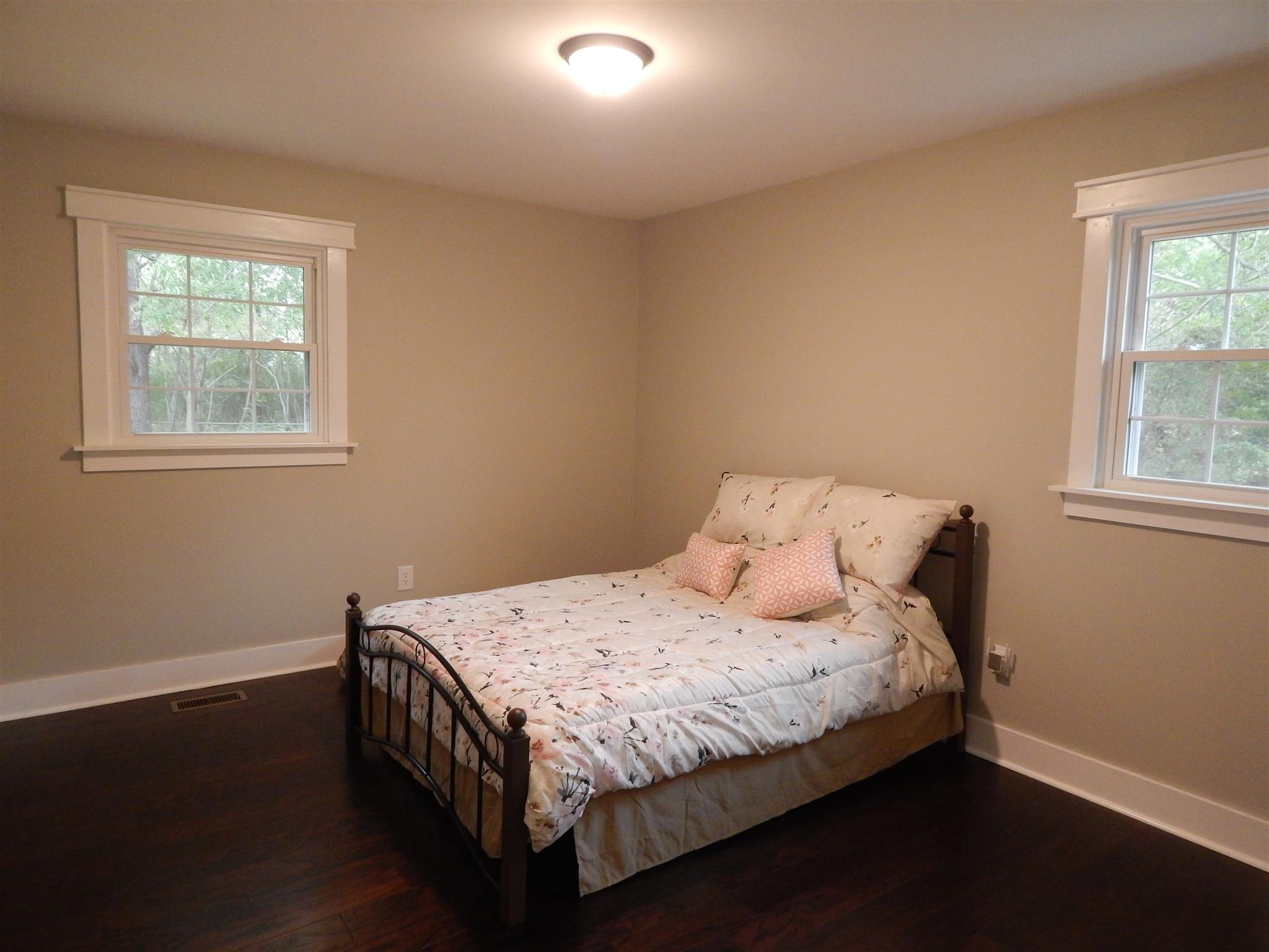 83 You Take It Road Ardmore, TN 38449 - Photo 13 of 30 a bedroom with a bed and wooden floor