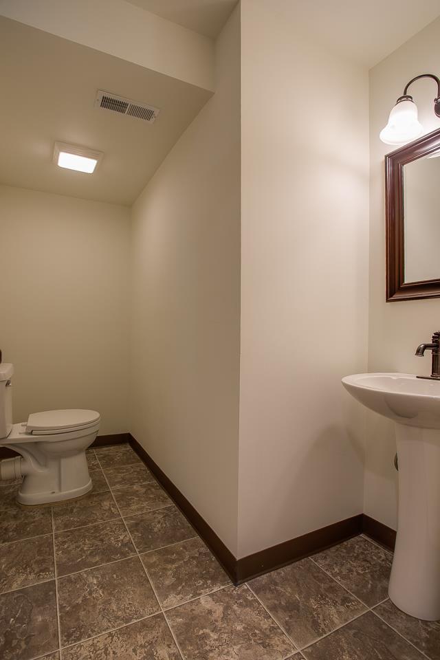 83 You Take It Road Ardmore, TN 38449 - Photo 23 of 30 a bathroom with a sink toilet and a mirror